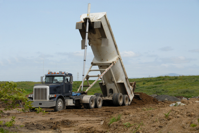 An image of a dump trailer dumping out the material.